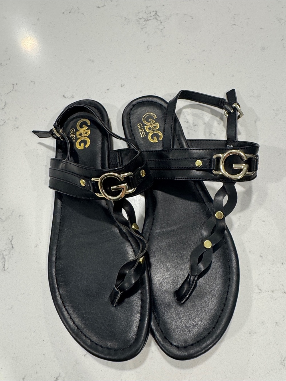 GUESS Black Leather T-Strap Sandals with Gold G Accent